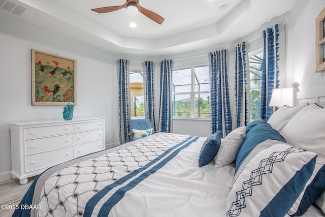 bedroom featuring a tray ceiling and ceiling fan