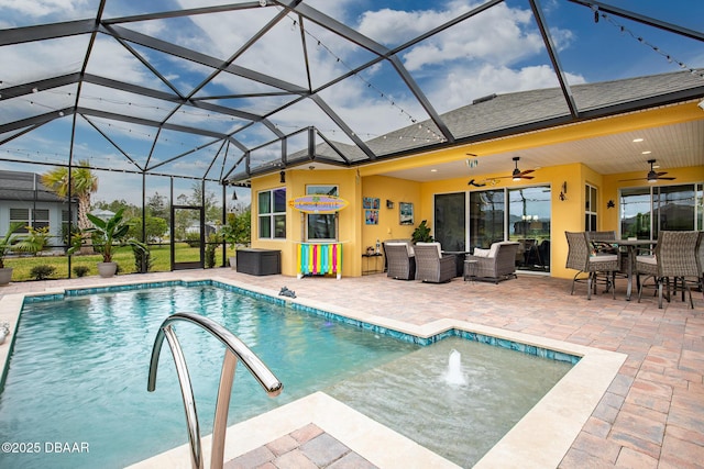 view of swimming pool with outdoor lounge area, a lanai, a patio area, and ceiling fan