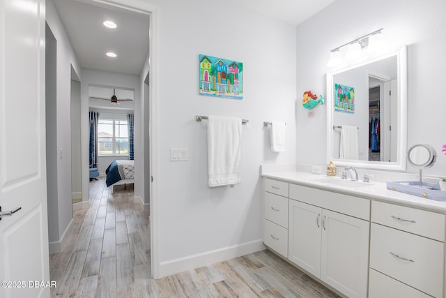 bathroom featuring hardwood / wood-style floors, ceiling fan, and vanity