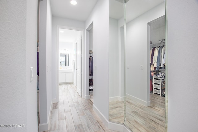 hallway with light hardwood / wood-style flooring