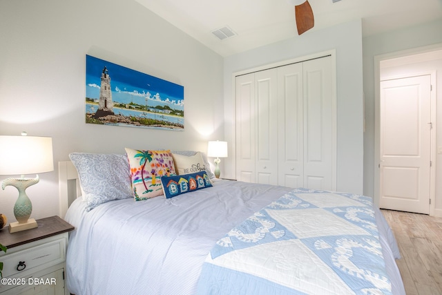 bedroom featuring ceiling fan, a closet, and light hardwood / wood-style flooring