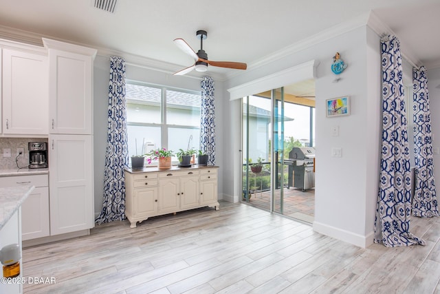 dining room with ceiling fan, crown molding, and light hardwood / wood-style flooring