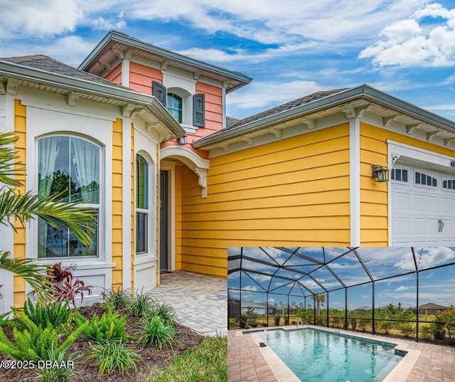 exterior space featuring a garage, glass enclosure, and a patio area