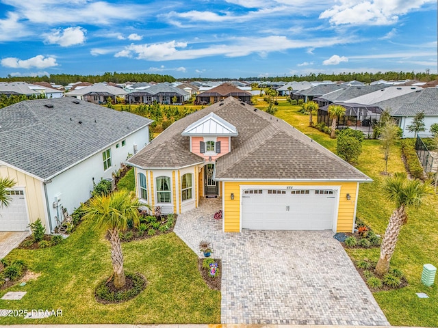 view of front of property with a front lawn and a garage