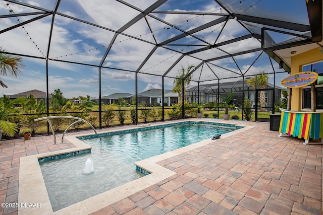 view of swimming pool with a patio area and a lanai