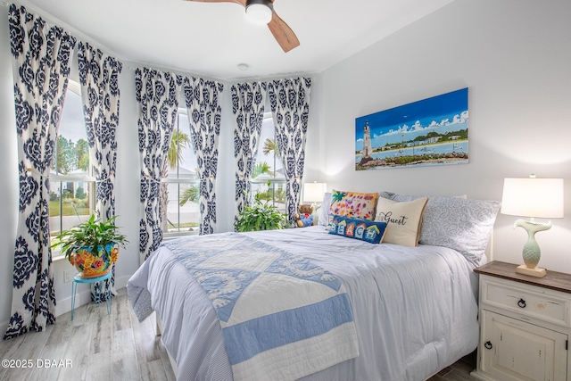 bedroom with ceiling fan and light hardwood / wood-style floors