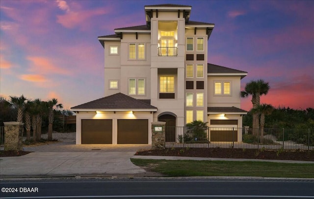 view of front of home featuring a balcony and a garage