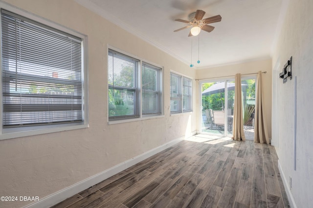 empty room with crown molding, ceiling fan, and hardwood / wood-style flooring