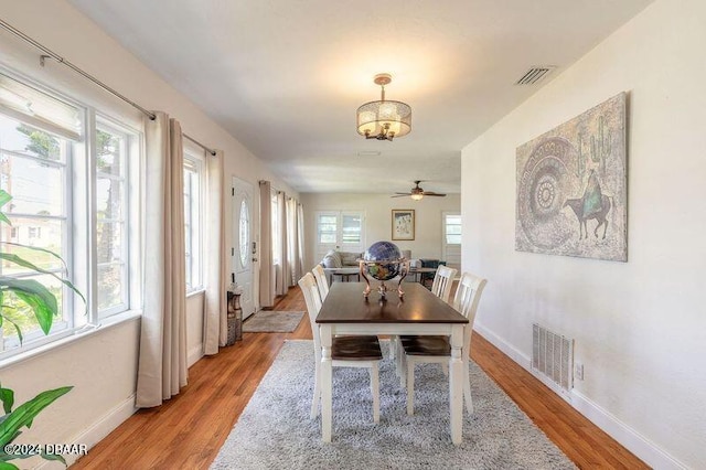 dining area featuring light wood-type flooring, plenty of natural light, and ceiling fan