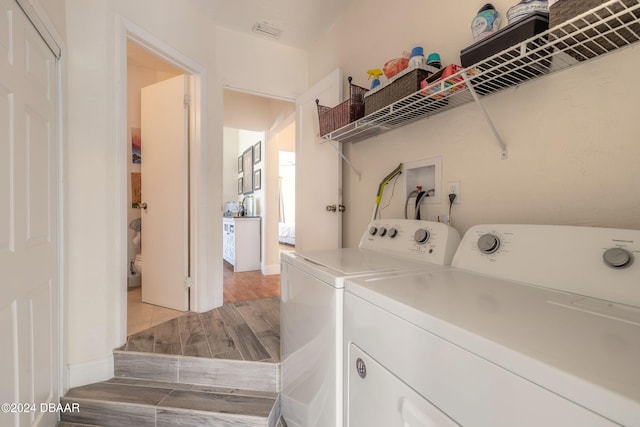 washroom featuring separate washer and dryer and hardwood / wood-style floors