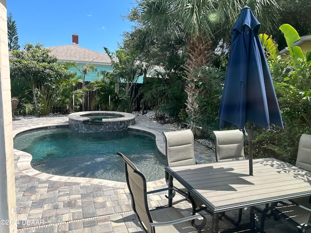 view of swimming pool with an in ground hot tub and a patio