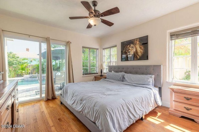 bedroom with light wood-type flooring, access to outside, multiple windows, and ceiling fan