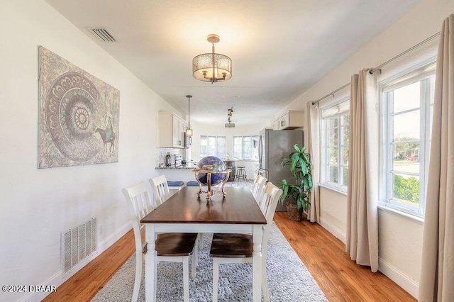 dining space with light hardwood / wood-style flooring