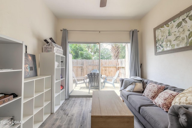 living room featuring ceiling fan and light hardwood / wood-style flooring