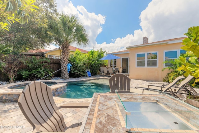 view of pool featuring an in ground hot tub and a patio