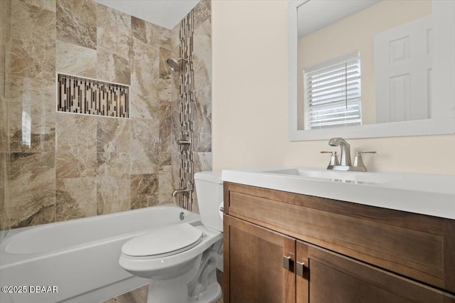 full bathroom with vanity, toilet, and tiled shower / bath