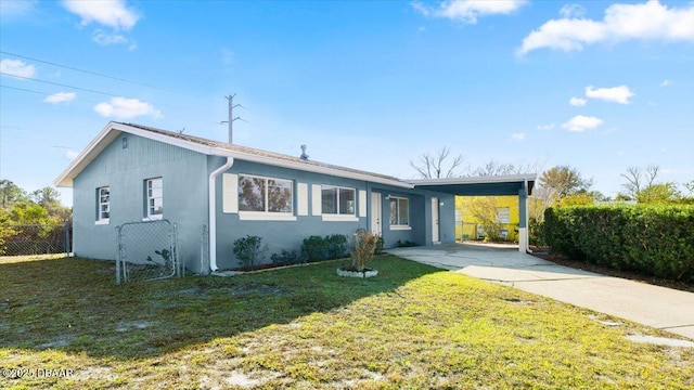 ranch-style home with a carport and a front lawn