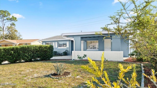 ranch-style house with a front lawn