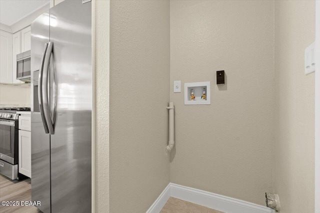 laundry room featuring hookup for a washing machine and light wood-type flooring