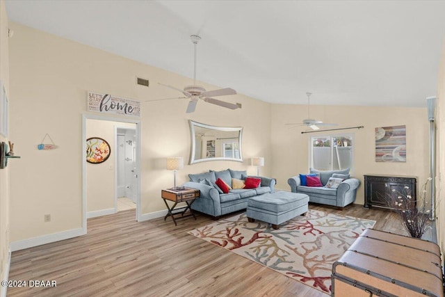 living room with ceiling fan, light hardwood / wood-style floors, and lofted ceiling