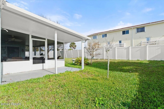 view of yard with a sunroom and a patio