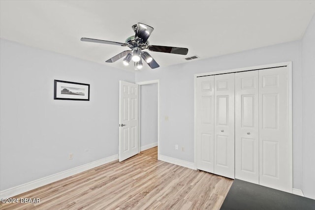 unfurnished bedroom with ceiling fan, a closet, and light hardwood / wood-style flooring