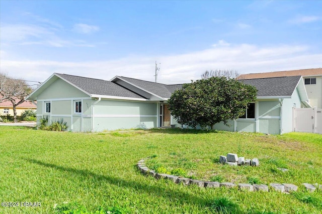 rear view of property featuring a lawn