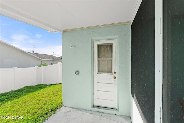 entrance to property with a yard