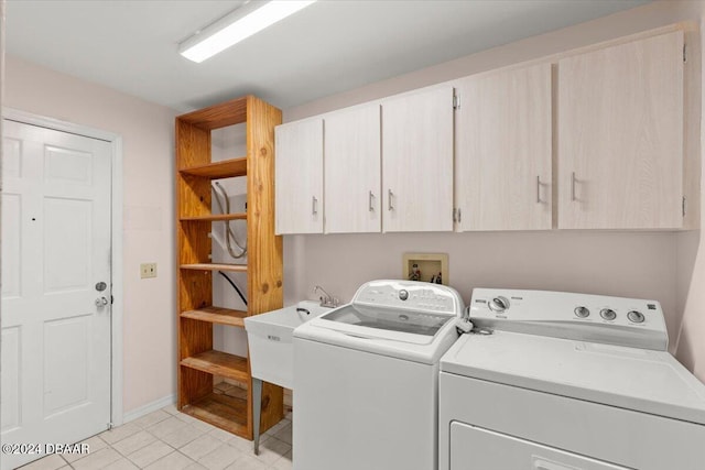 laundry area with washer and clothes dryer, cabinets, and sink