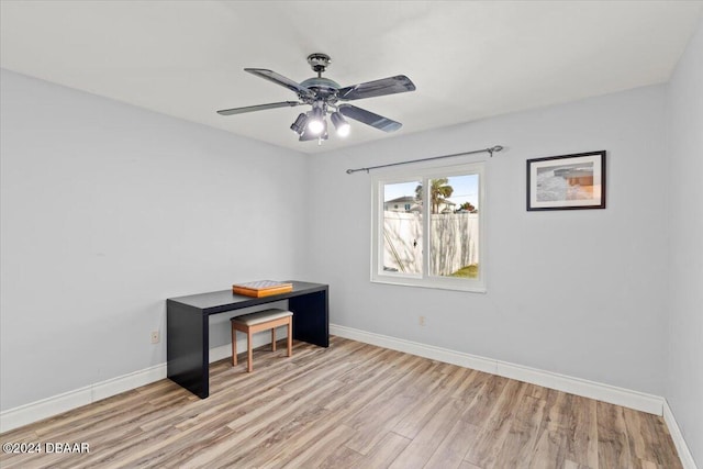 spare room with light wood-type flooring and ceiling fan