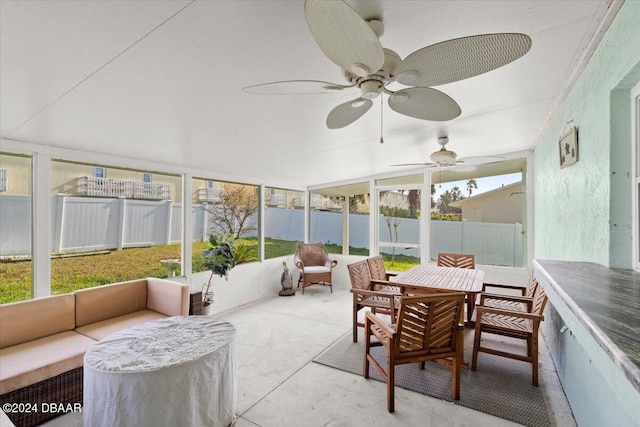 sunroom featuring ceiling fan