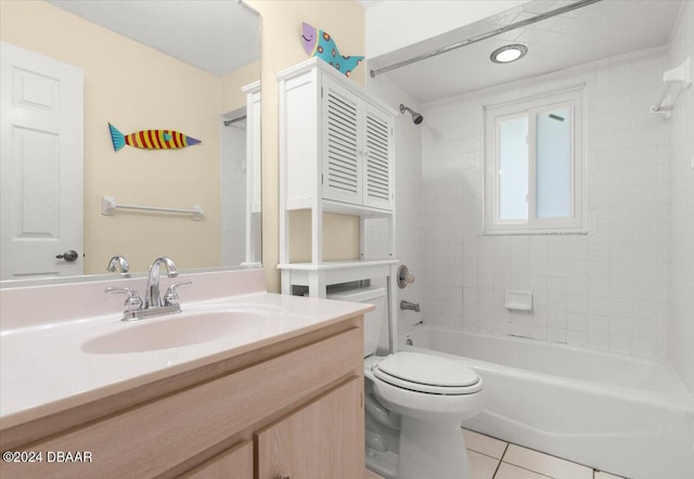 full bathroom featuring tiled shower / bath, tile patterned flooring, vanity, and toilet