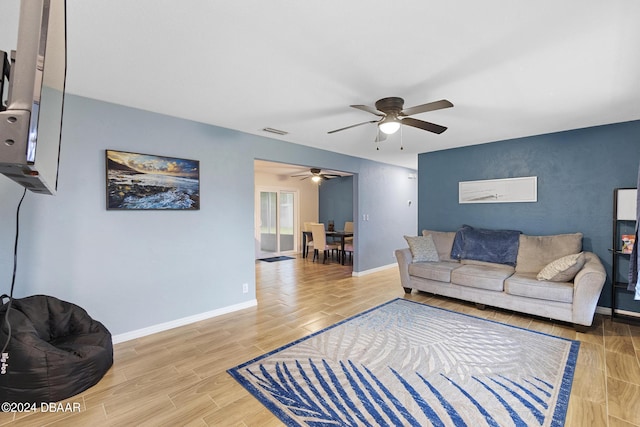 living room with wood-type flooring and ceiling fan