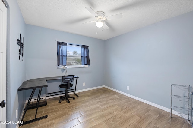 office space featuring ceiling fan, a textured ceiling, and light hardwood / wood-style flooring