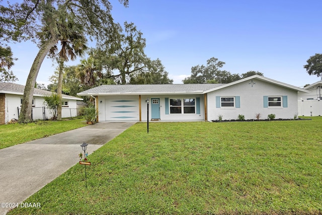 ranch-style home with a garage and a front yard