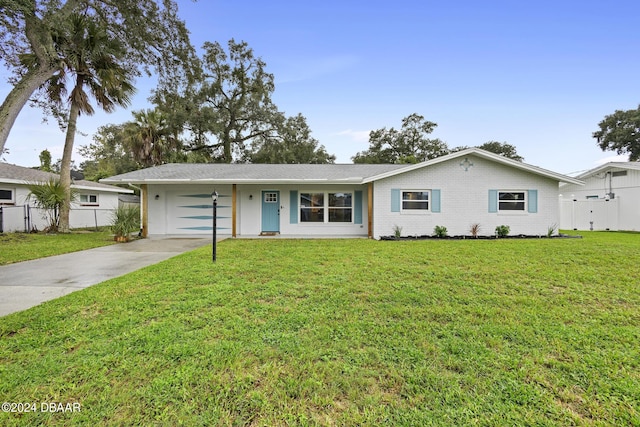 single story home featuring a garage and a front lawn