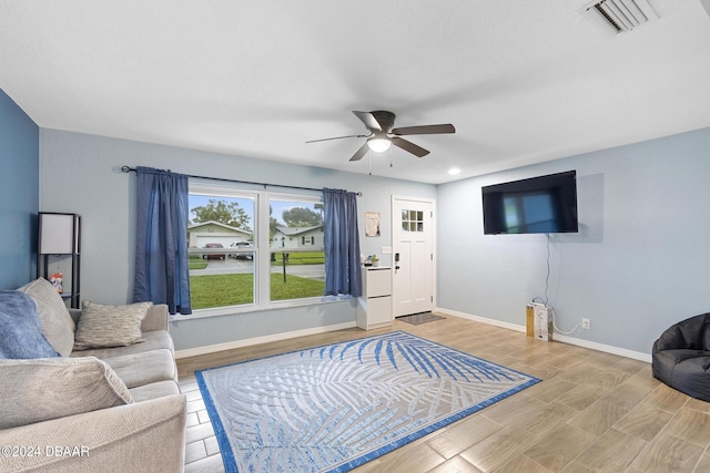 living room with wood-type flooring and ceiling fan