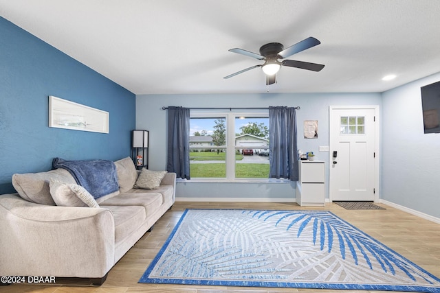 living room with hardwood / wood-style floors and ceiling fan