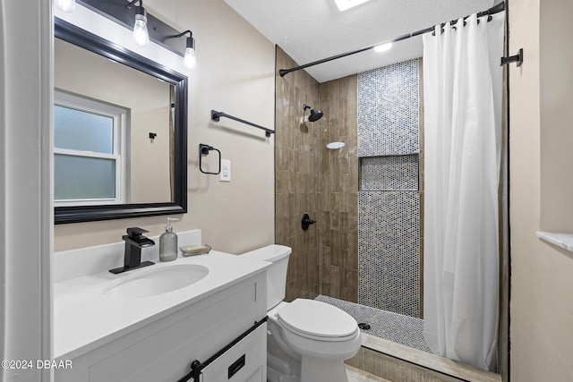 bathroom featuring vanity, curtained shower, and toilet