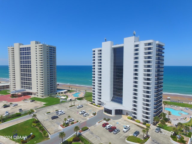 birds eye view of property featuring a water view and a view of the beach