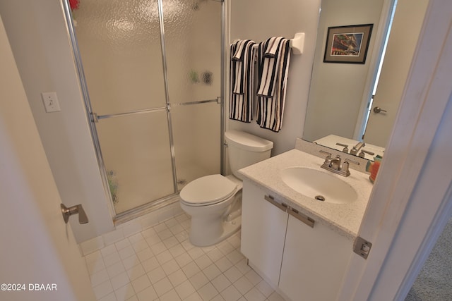 bathroom with vanity, tile patterned floors, toilet, and an enclosed shower