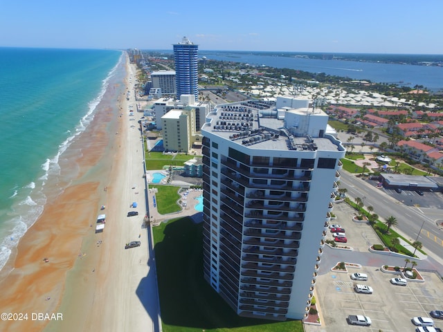 birds eye view of property with a view of the beach and a water view