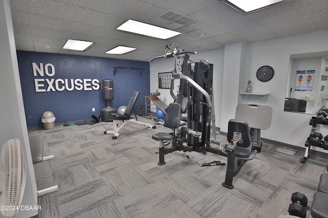 exercise room featuring a drop ceiling and carpet flooring