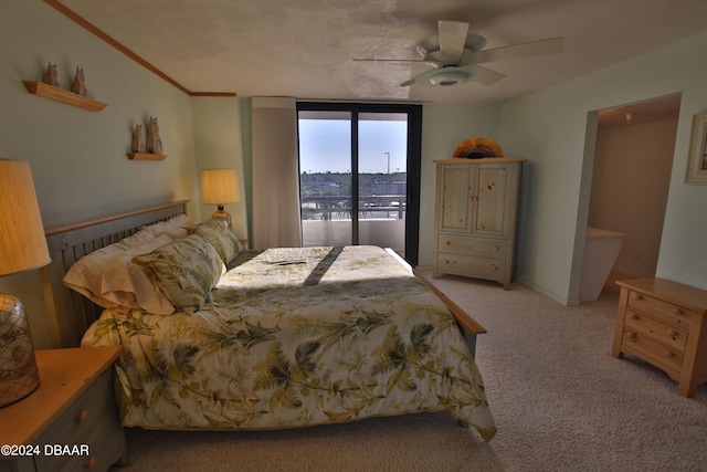 carpeted bedroom with ceiling fan, ornamental molding, and access to outside