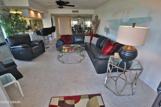 carpeted living room with ceiling fan