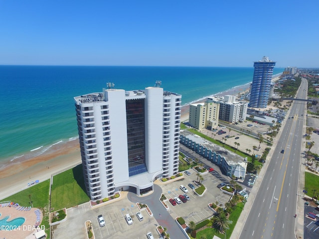 birds eye view of property with a view of the beach and a water view