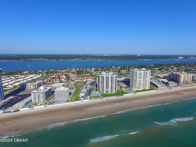 birds eye view of property featuring a beach view and a water view