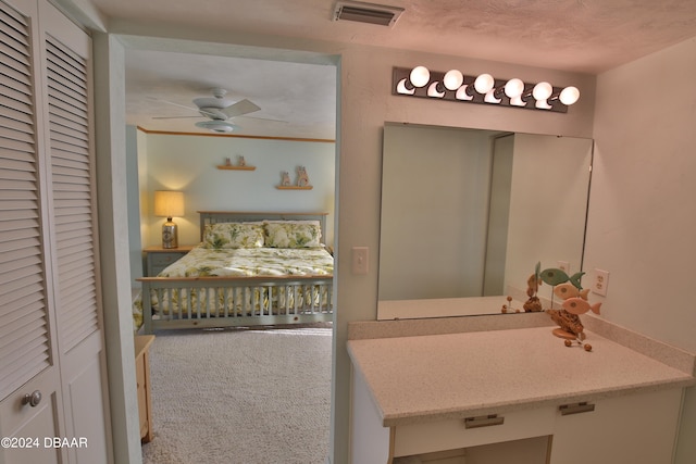 bathroom featuring a textured ceiling, vanity, and ceiling fan