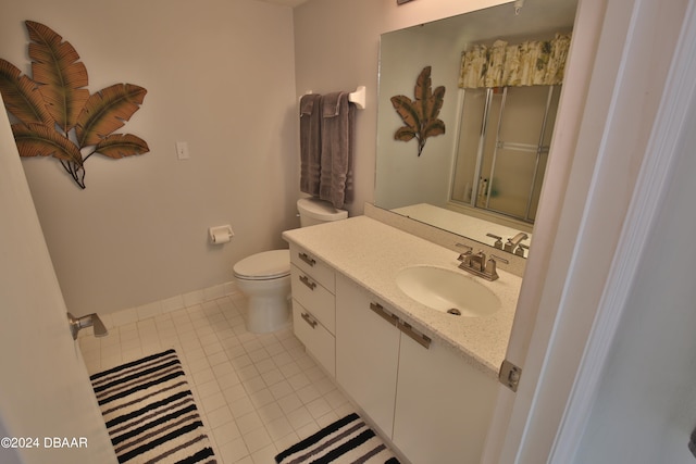 bathroom with toilet, an enclosed shower, vanity, and tile patterned floors