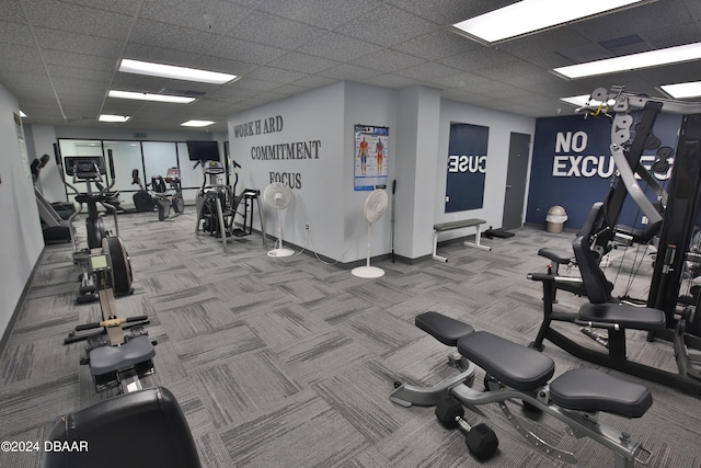 workout area with a drop ceiling and carpet floors